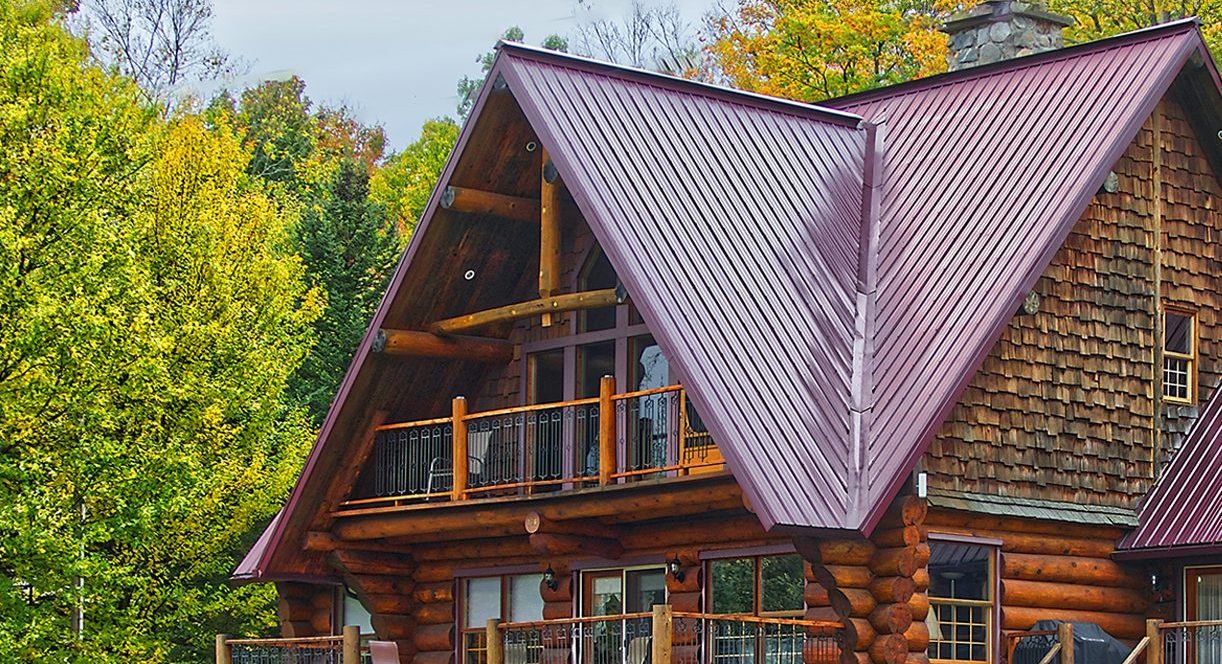 The exterior of a log cabin in the fall weather. 