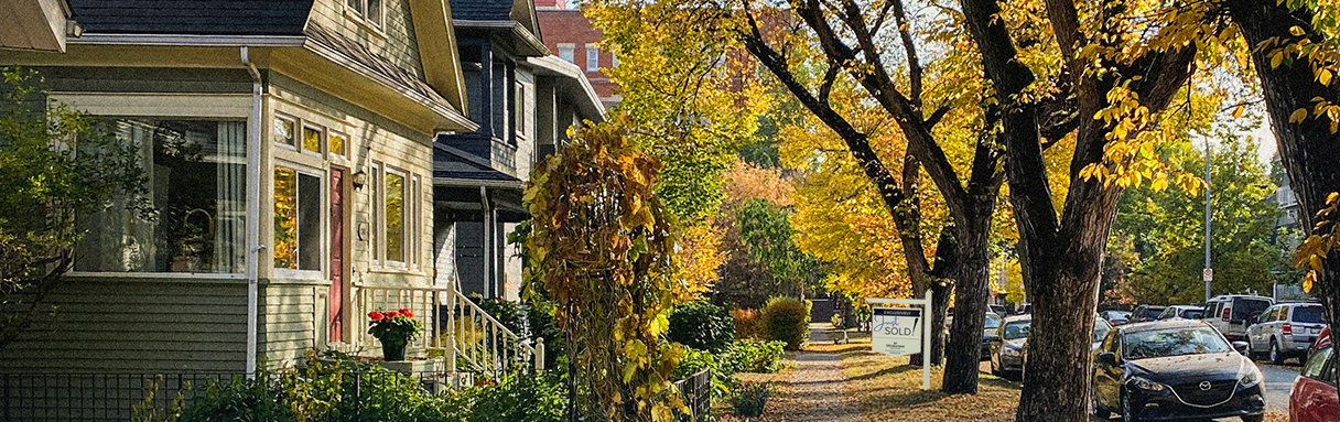Fall street with changing leaves and a for sale sine for Windermere reality agency,.