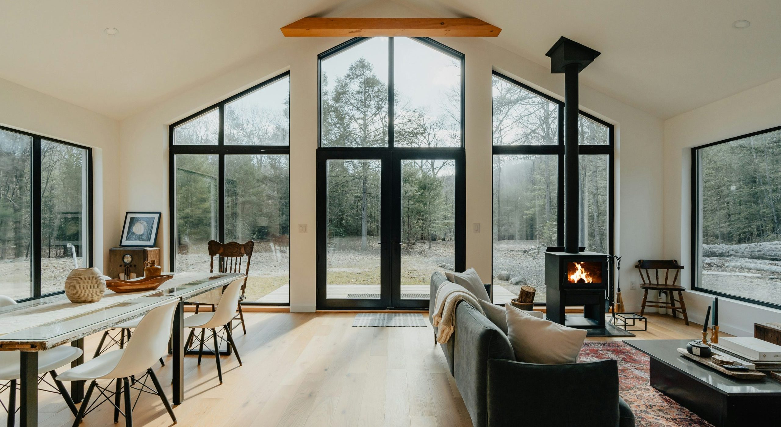 Interior shot of a cozy home, looking out to forest trees.