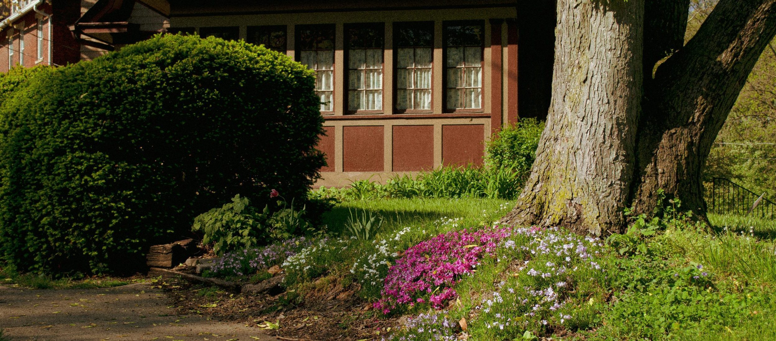 Facing a home with some spring flowers in front of it